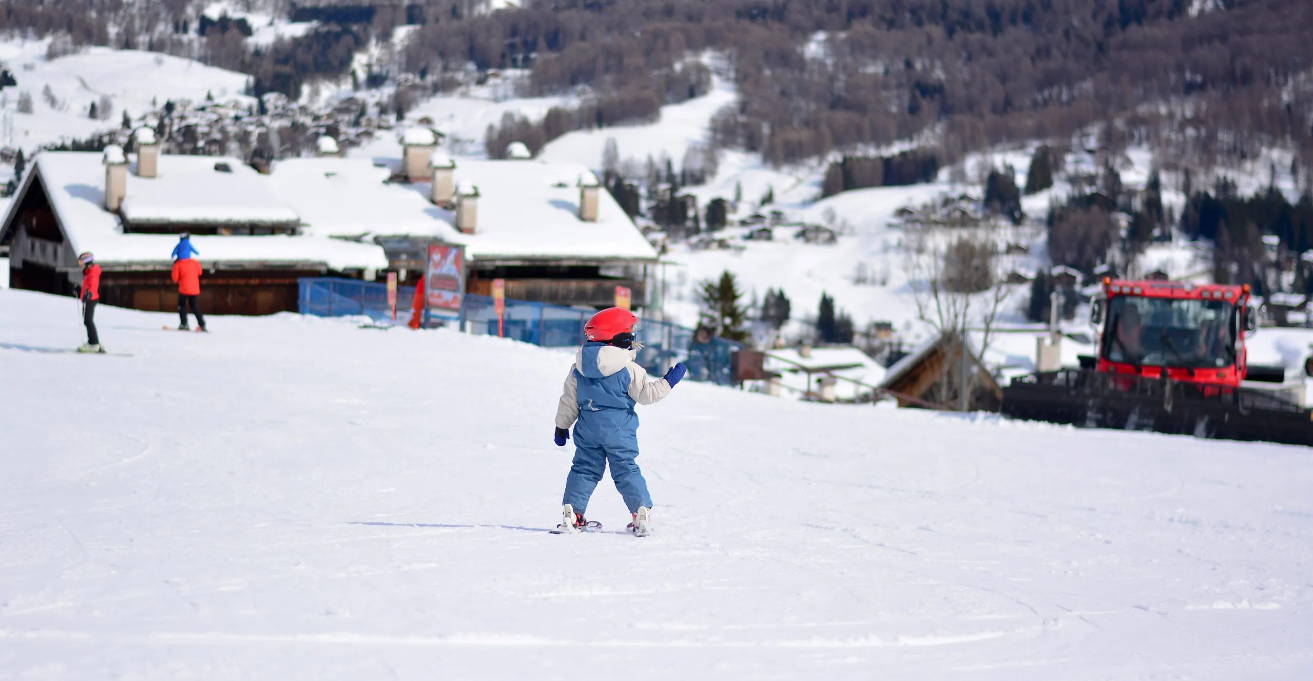 Child on skis at Kronplatz ski resort.
